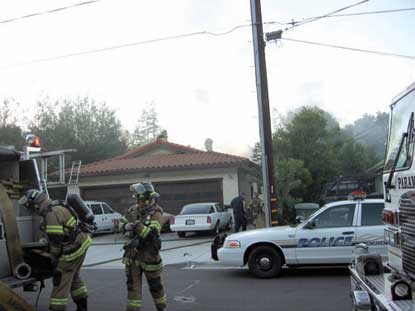 Woman arrested after rescue from burning home