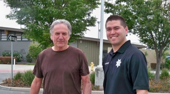 Police officer, volunteer rescue owlet from water slide