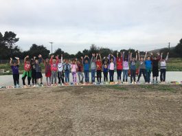 Charter students line school track with canned goods