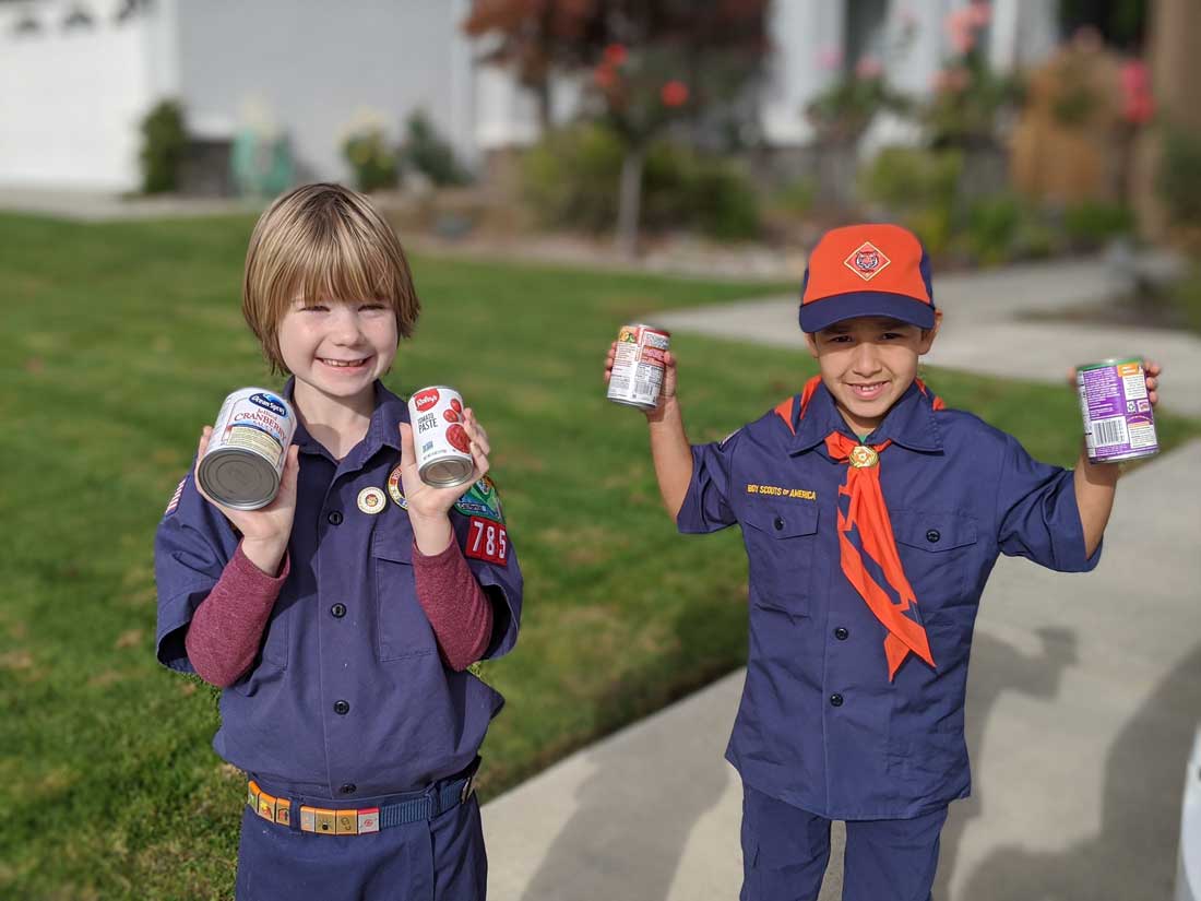 New scouts receive uniforms, donate food