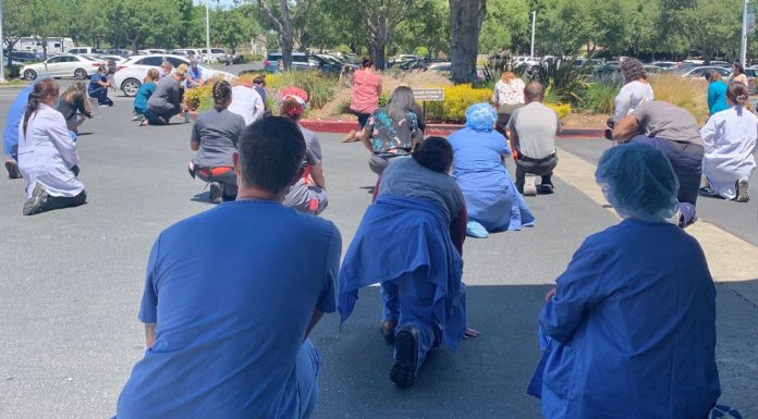 Saint Louise, county health workers take a knee