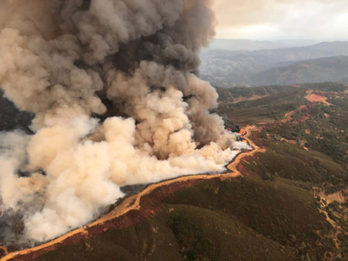 Henry W. Coe State Park, shows a dramatic view of control burns set on the west side of a dozer line