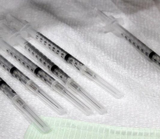 CA health officials urge vaccination for flu, Covid covid-19 vaccine syringe dose booster