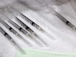 Health officials urge public to vaccinate against measles Vaccine syringe