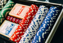 The Role of Independent Comparison Platforms in Building Trust in iGaming Red, blue, white, and green poker chips and poker cards.