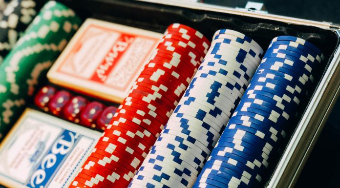 The Role of Independent Comparison Platforms in Building Trust in iGaming Red, blue, white, and green poker chips and poker cards.