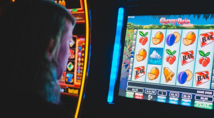 Local Players Face New Reality as State Cracks Down on Sweepstakes Machines Person using slot machine