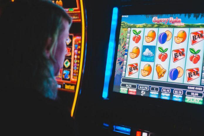 State cracks down on sweepstakes machines Person using slot machine
